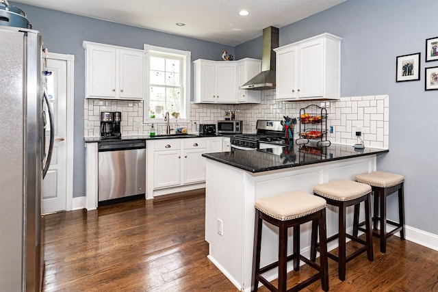 2212 228th Pl, Ames, IA 50014 - kitchen with stainless steel appliances, wall chimney exhaust hood, a peninsula, a sink, and decorative backsplash