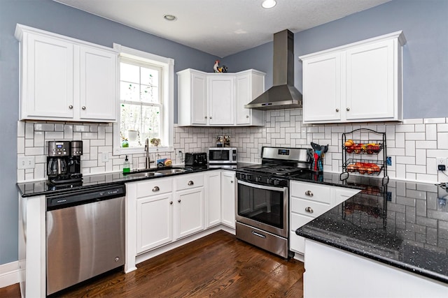 2212 228th Pl, Ames, IA 50014 - kitchen with appliances with stainless steel finishes, wall chimney range hood, a sink, white cabinetry, and recessed lighting