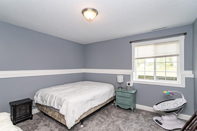 2212 228th Pl, Ames, IA 50014 - bedroom with carpet, baseboards, and a textured ceiling