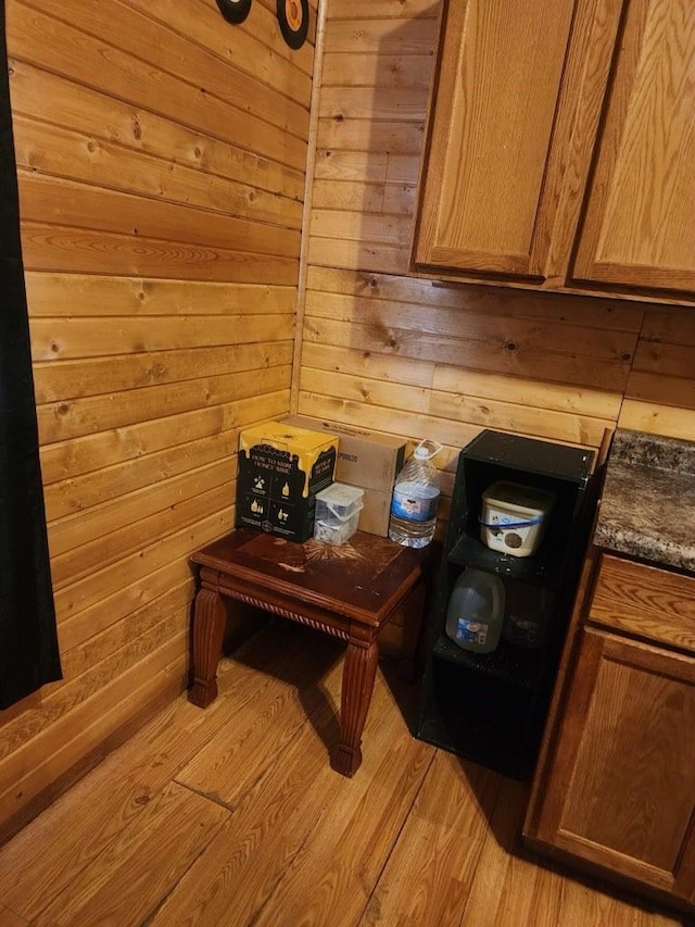 1512 Osceola Ave, Chariton, IA 50049 - kitchen view of light wood-style flooring, dark countertops, and wood walls