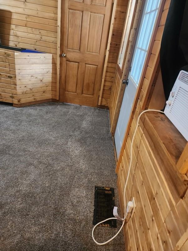 1512 Osceola Ave, Chariton, IA 50049 - detailed view of carpet flooring and wood walls