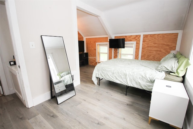1035 65th St, Windsor Heights, IA 50324 - bedroom featuring lofted ceiling, wood finished floors, and wooden walls