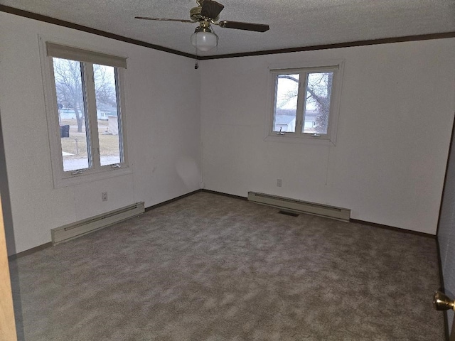 205 Amy Ln, Mount Ayr, IA 50854 - unfurnished room featuring a baseboard radiator, ornamental molding, plenty of natural light, a textured ceiling, and carpet flooring