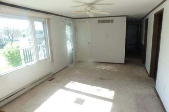 205 Amy Ln, Mount Ayr, IA 50854 - unfurnished room featuring baseboard heating and ceiling fan