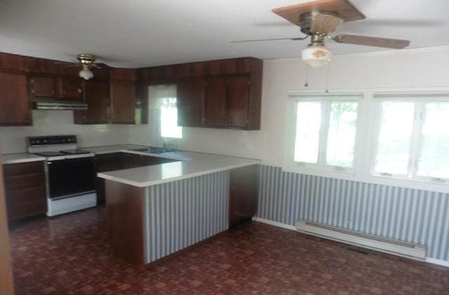 205 Amy Ln, Mount Ayr, IA 50854 - kitchen featuring electric stove, ceiling fan, a baseboard heating unit, under cabinet range hood, and dark flooring