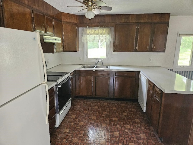 205 Amy Ln, Mount Ayr, IA 50854 - kitchen with white appliances, light countertops, backsplash, a peninsula, and a ceiling fan
