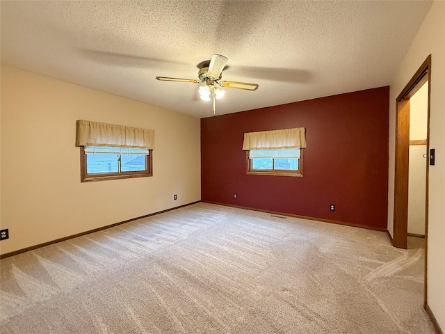 1545 5th St, Boone, IA 50036 - spare room with light colored carpet, ceiling fan, a textured ceiling, and baseboards