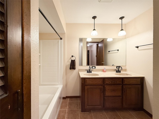 1545 5th St, Boone, IA 50036 - bathroom with double vanity, tile patterned flooring, washtub / shower combination, and baseboards