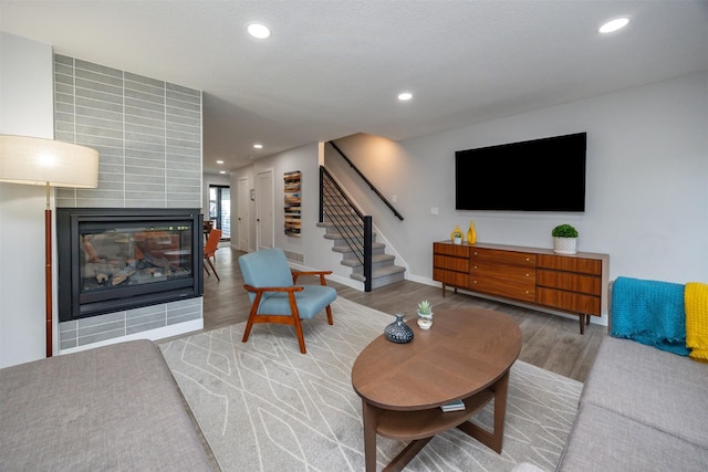 6196 Terrace Dr Unit 2, Johnston, IA 50131 - living area with wood finished floors, stairway, recessed lighting, and a tile fireplace