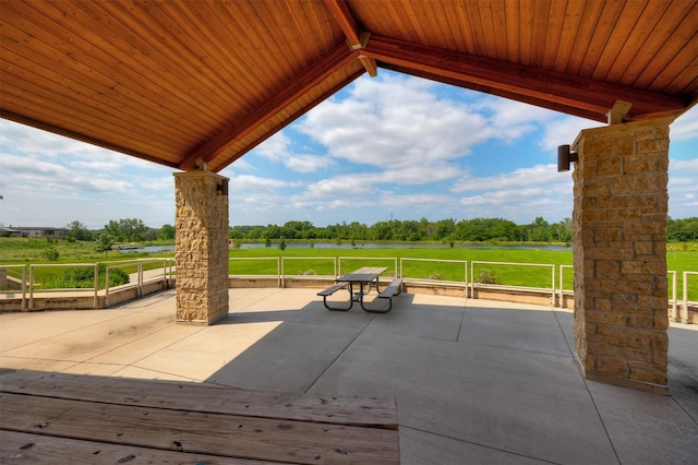 6196 Terrace Dr Unit 2, Johnston, IA 50131 - view of patio / terrace with a water view and view of wooded area