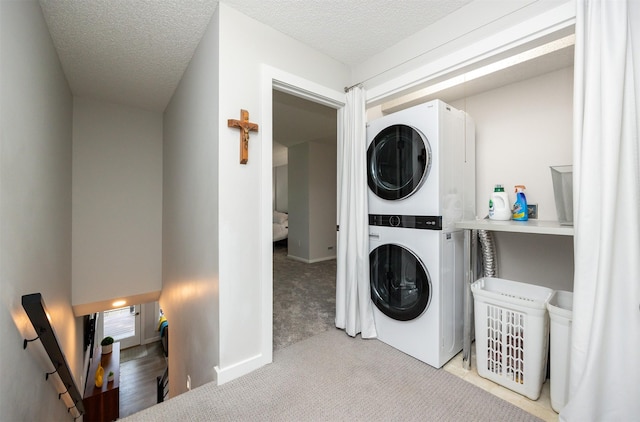 6196 Terrace Dr Unit 2, Johnston, IA 50131 - laundry area with estacked washer and dryer, carpet flooring, and a textured ceiling