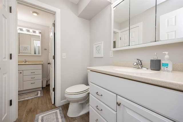 6196 Terrace Dr Unit 2, Johnston, IA 50131 - bathroom with toilet, vanity, wood finished floors, and baseboards