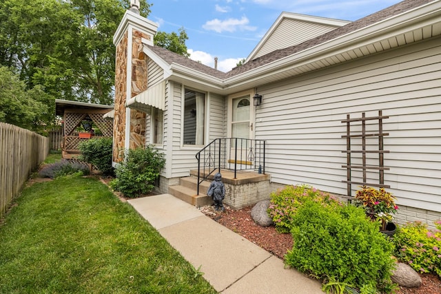 3916 92nd Dr, Urbandale, IA 50322 - view of exterior entry with a chimney and roof with shingles