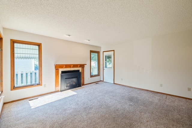 3916 92nd Dr, Urbandale, IA 50322 - unfurnished living room with carpet floors, a fireplace with flush hearth, and a textured ceiling