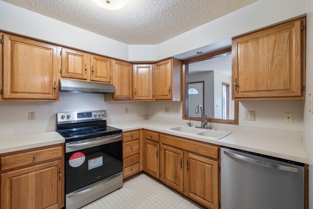 3916 92nd Dr, Urbandale, IA 50322 - kitchen with appliances with stainless steel finishes, under cabinet range hood, a textured ceiling, light countertops, and brown cabinets