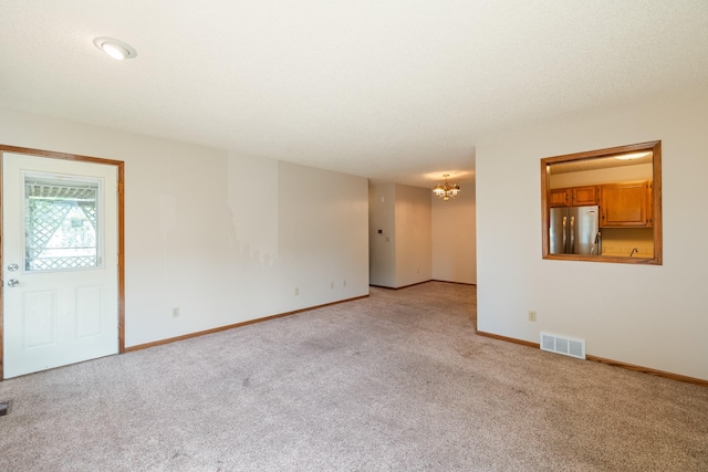 3916 92nd Dr, Urbandale, IA 50322 - unfurnished room with light colored carpet and a chandelier