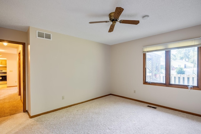 3916 92nd Dr, Urbandale, IA 50322 - empty room with light colored carpet, a ceiling fan, a smoke detector, and a textured ceiling