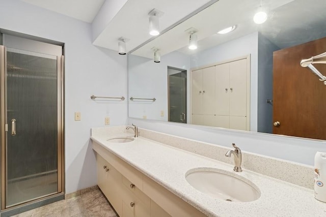 2110 Ashmore Dr, Ames, IA 50014 - full bath with double vanity, baseboards, and a shower with shower door
