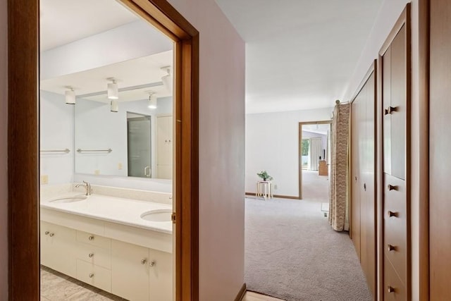 2110 Ashmore Dr, Ames, IA 50014 - hallway with light colored carpet and a sink