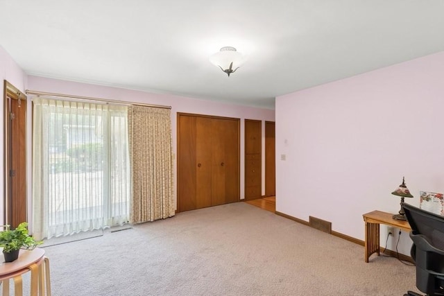 2110 Ashmore Dr, Ames, IA 50014 - carpeted bedroom featuring baseboards and two closets