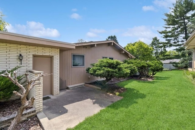 2110 Ashmore Dr, Ames, IA 50014 - property entrance with a lawn and a patio