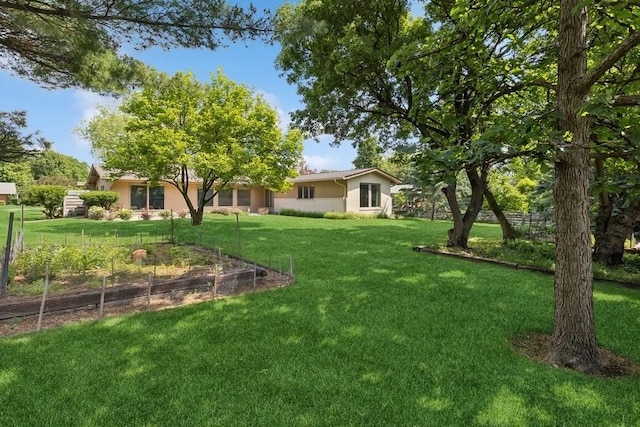 2110 Ashmore Dr, Ames, IA 50014 - view of green lawn with a vegetable garden