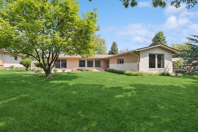 2110 Ashmore Dr, Ames, IA 50014 - rear view of property with brick siding and a yard