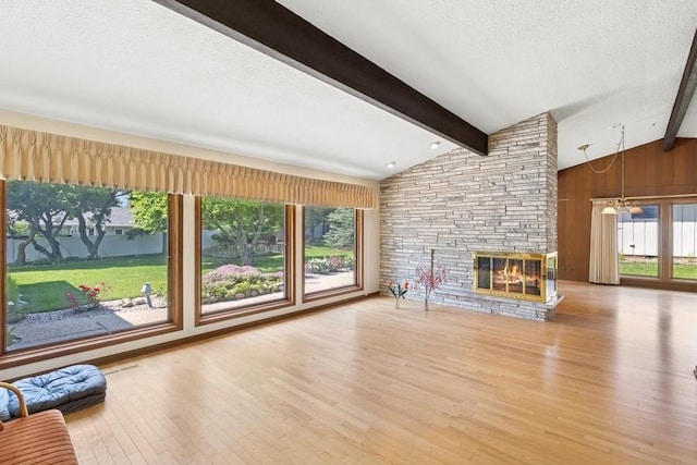 2110 Ashmore Dr, Ames, IA 50014 - unfurnished living room featuring wood finished floors, a fireplace, and a textured ceiling