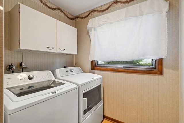 2110 Ashmore Dr, Ames, IA 50014 - laundry room featuring separate washer and dryer and cabinet space