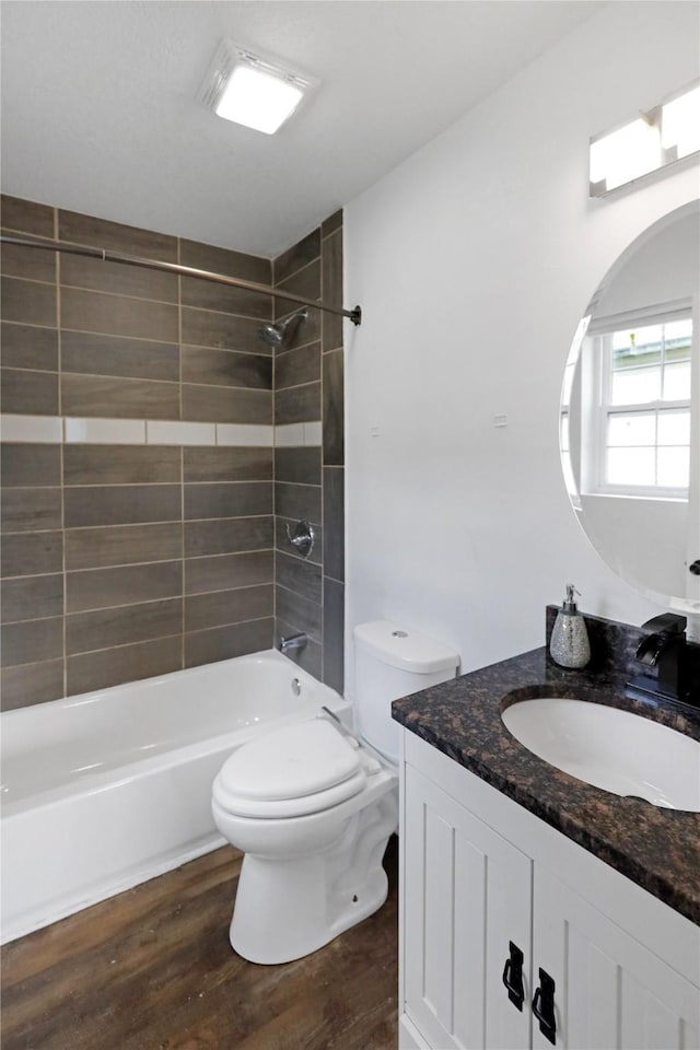 1908 E Walnut St, Des Moines, IA 50316 - bathroom featuring vanity, wood finished floors, bathing tub / shower combination, and toilet