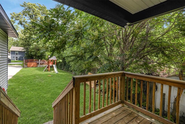 1908 E Walnut St, Des Moines, IA 50316 - wooden deck featuring a playground and a lawn