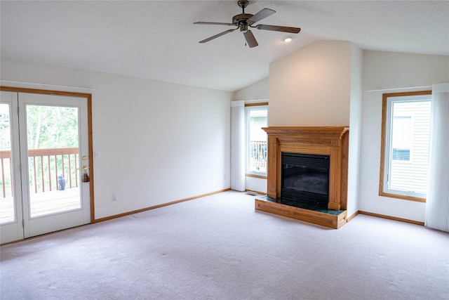 1126 SE Mallard Creek Dr, Ankeny, IA 50021 - unfurnished living room with carpet, vaulted ceiling, ceiling fan, baseboards, and a glass covered fireplace