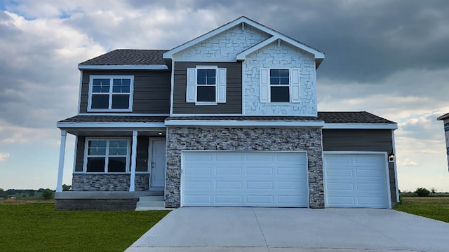 450 Meadows Ct, Polk City, IA 50226 - view of front facade with stone siding, concrete driveway, covered porch, and a front yard