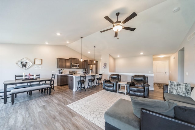 602 NE 57th St, Ankeny, IA 50021 - living room with lofted ceiling, ceiling fan, and light wood finished floors