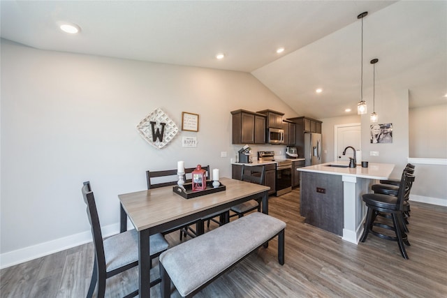 602 NE 57th St, Ankeny, IA 50021 - dining room with dark wood-style flooring, baseboards, lofted ceiling, and recessed lighting