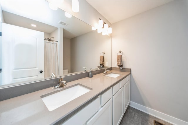 602 NE 57th St, Ankeny, IA 50021 - full bath with baseboards, double vanity, toilet, and tile patterned floors