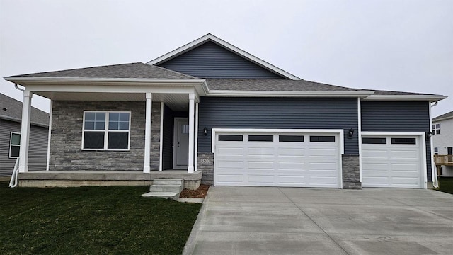 440 Meadows Ct, Polk City, IA 50226 - single story home with stone siding, concrete driveway, a garage, a front yard, and a shingled roof