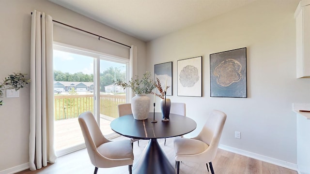 484 Kinley Dr, Waukee, IA 50263 - dining area featuring light wood-style floors and baseboards