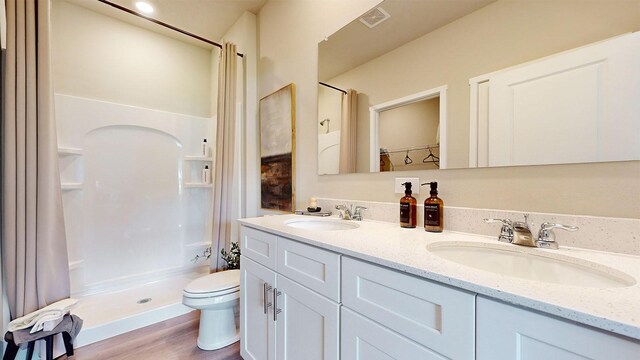 480 Kinley Dr, Waukee, IA 50263 - full bathroom with toilet, a shower with curtain, double vanity, and wood finished floors