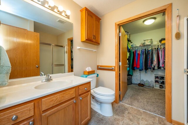 168 SE Sweetgrass Ln, Pleasant Hill, IA 50327 - full bath with a shower stall, vanity, and a spacious closet