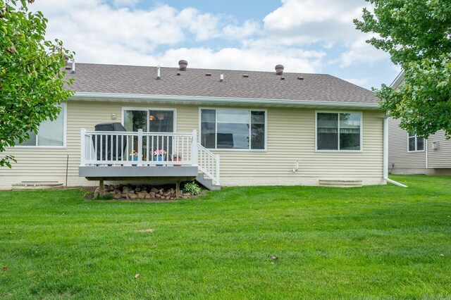168 SE Sweetgrass Ln, Pleasant Hill, IA 50327 - back of property with a deck, a yard, and a shingled roof