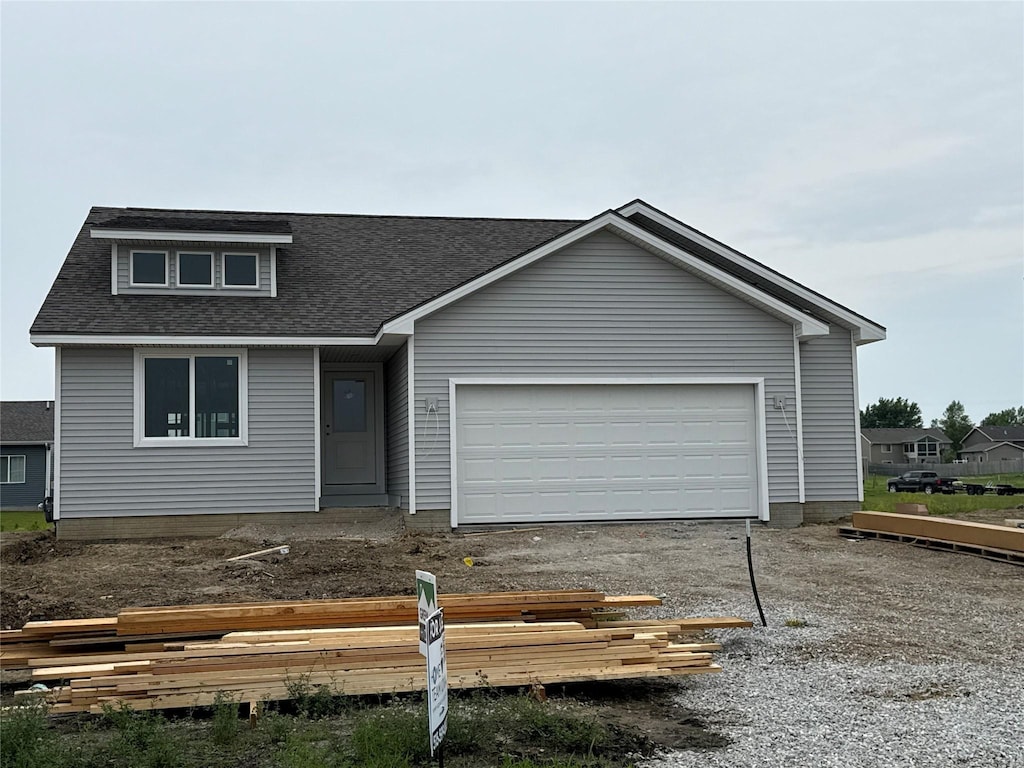 317 NE Chalet St, Elkhart, IA 50073 - view of front of home with roof with shingles, a garage, and driveway
