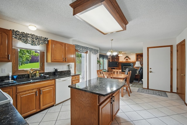 4623 62nd St, Urbandale, IA 50322 - kitchen with dishwasher, a textured ceiling, brown cabinets, a chandelier, and light tile patterned flooring