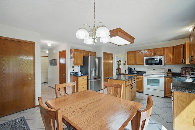 4623 62nd St, Urbandale, IA 50322 - kitchen featuring appliances with stainless steel finishes, light tile patterned flooring, a chandelier, a kitchen island, and brown cabinetry