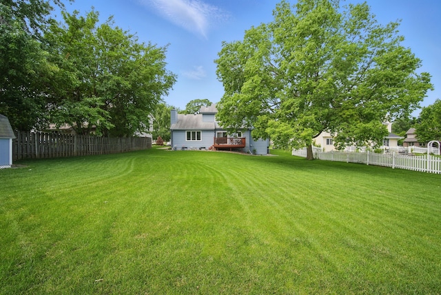 4623 62nd St, Urbandale, IA 50322 - fenced backyard featuring a wooden deck and a storage unit