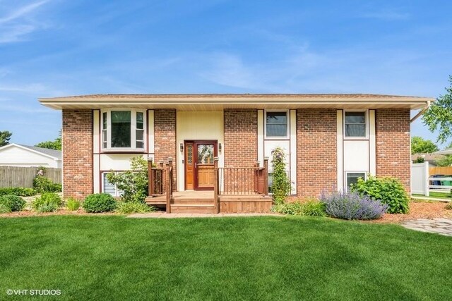 4404 71st Pl, Urbandale, IA 50322 - raised ranch featuring a front yard and brick siding