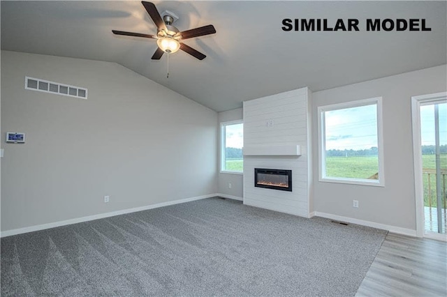 25088 Bluebird Cir, Adel, IA 50003 - unfurnished living room featuring ceiling fan, lofted ceiling, a large fireplace, and wood finished floors