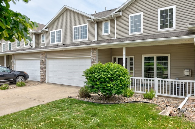10415 Hickory Dr Unit 9, Urbandale, IA 50322 - multi unit property with covered porch, a garage, concrete driveway, and a front yard