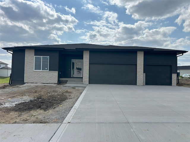 4192 NW 177th St, Clive, IA 50325 - prairie-style home featuring an attached garage, concrete driveway, and stone siding