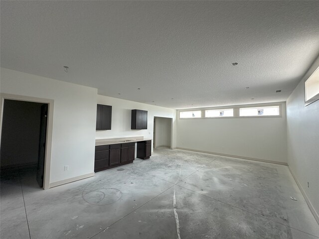 4192 NW 177th St, Clive, IA 50325 - unfurnished living room with concrete flooring and a textured ceiling